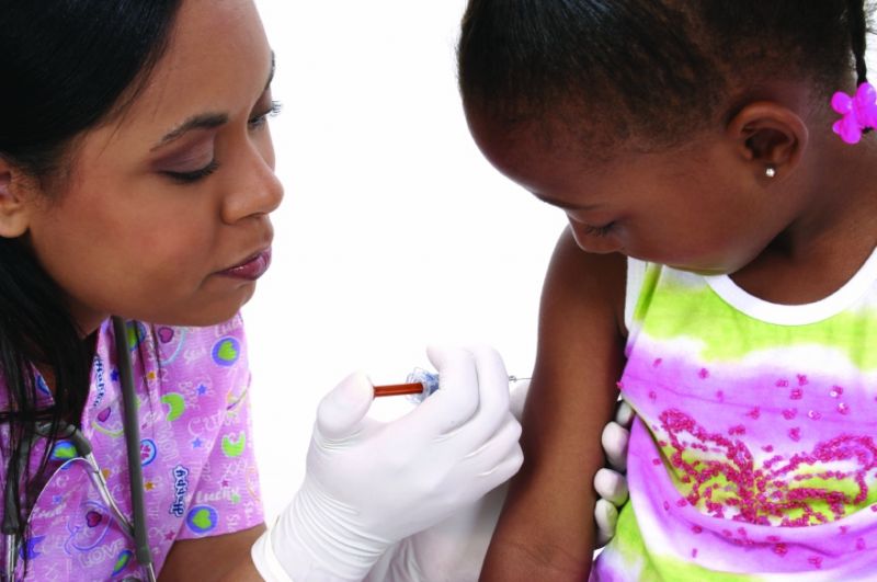 Woman injecting a child